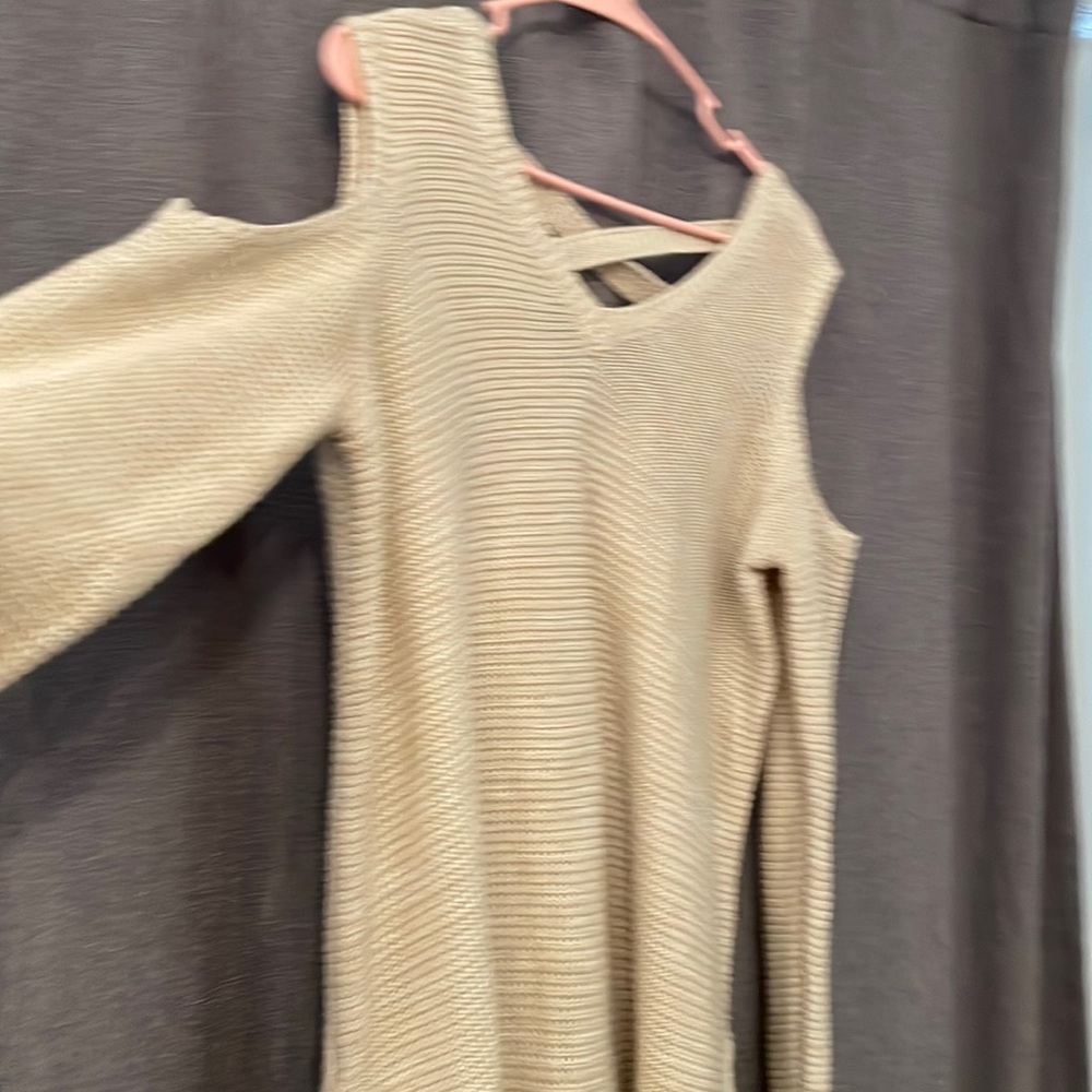 Sweater with shoulder cut outs crossed details in back. Long. Worn once